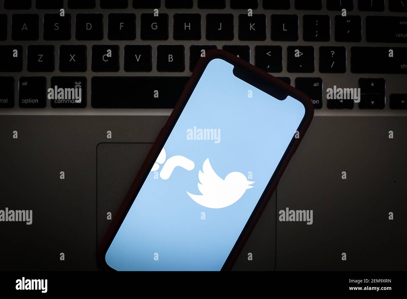 The Twitter logo is seen on a portable mobile device in this photo ...