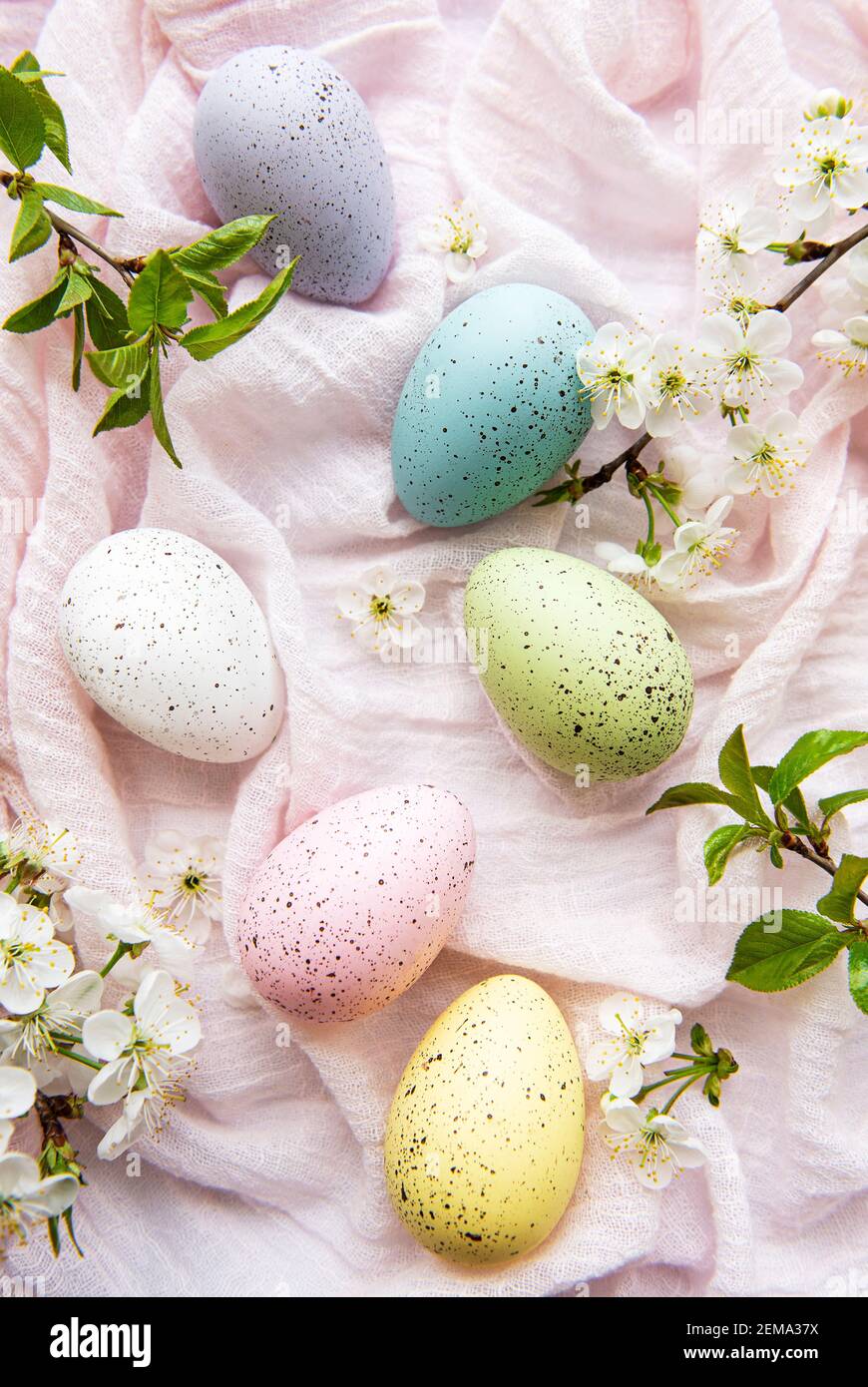 Easter eggs on pink fabric background with spring cherry blossom Stock ...