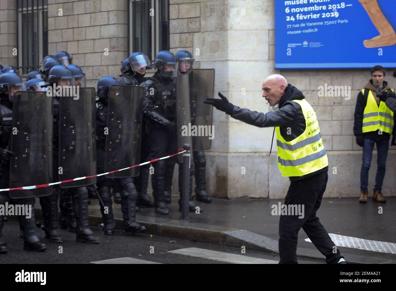 19 January 2019. Paris, France. Gilets Jaunes - Acte X take to the streets of Paris. A protester makes his feelings known to a wall of CRS riot police who have sealed a road along the route. An estimated 7,000 people took part in the looping 14 km route from Place des Invalides to protest tax hikes from the Government of Emmanuel Macron imposed on the people. An estimated 80,000 people took part in protests across the country. Regrettably the movement has attracted a violent element of agitators who often face off with riot police at the end of the marches which tends to deflect attention awa Stock Photo