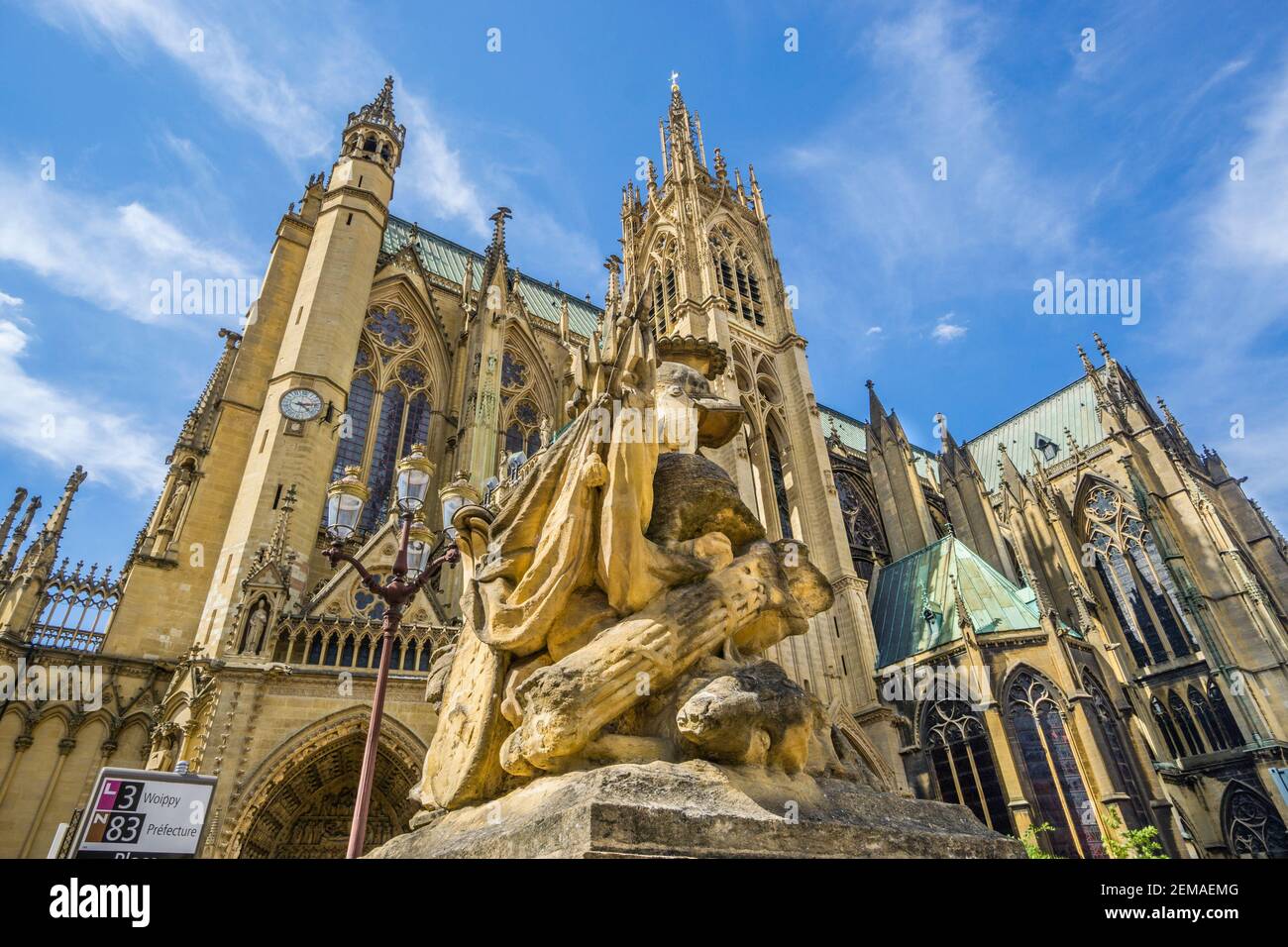 one the Place d'Armes martial symbolism sculptures with view of Metz cathedral's La Mutte tower and Horloge tower, Metz, Lorraine, Moselle department, Stock Photo