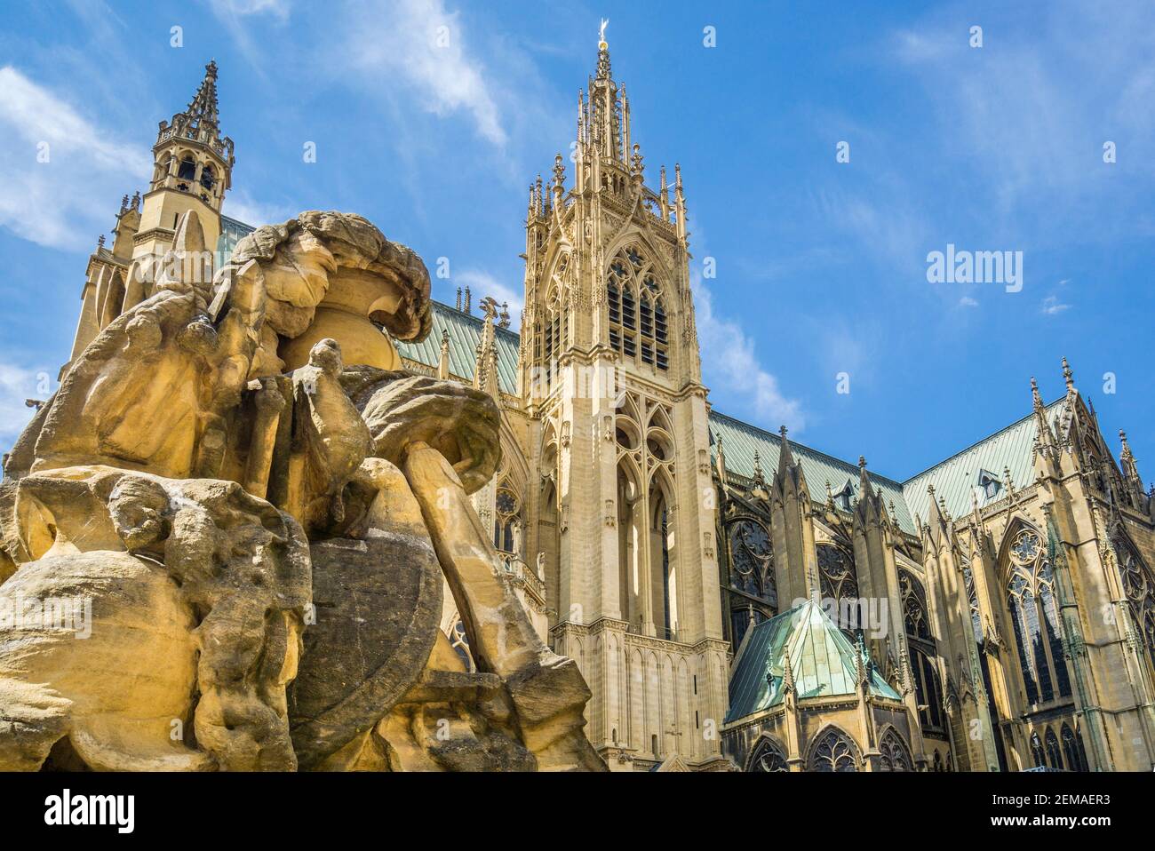 one the Place d'Armes martial symbolism sculptures with view of Metz cathedral's La Mutte tower and Horloge tower, Metz, Lorraine, Moselle department, Stock Photo