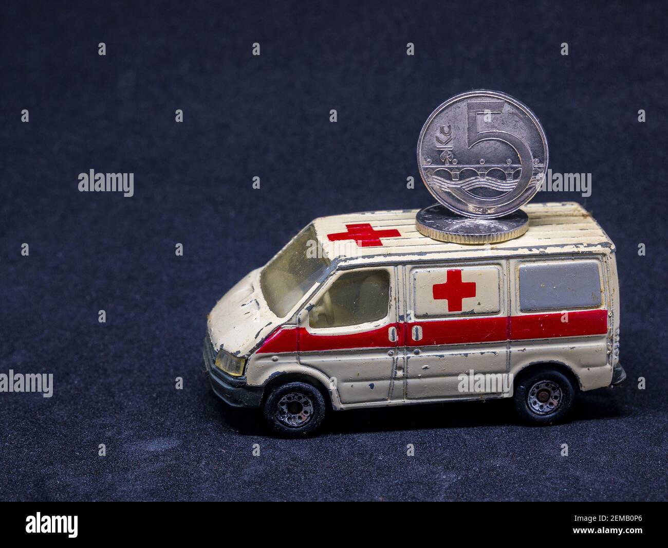 Usti nad Labem / Czech Republic - 11.29.2019: Old dusty ambulance toy car  with coin on it's roof - coin are Czech koruna Stock Photo - Alamy