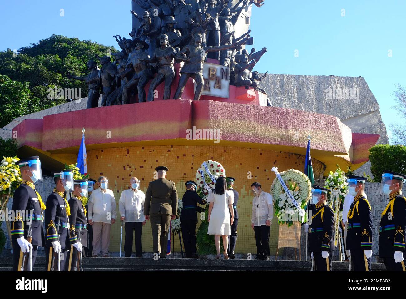 Manila, Philippines. 25th Feb, 2021. Government and military officials offer flowers in front of the People Power Monument as part of commemorating the 35th anniversary of EDSA Revolution in front of the People Power Monument. This year's theme is 'EDSA 2021: Kapayapaan, Paghilom, Pagbangon (Peace, Healing, Recovery), to reflect on the national efforts in the face of COVID-19 pandemic. Credit: Majority World CIC/Alamy Live News Stock Photo