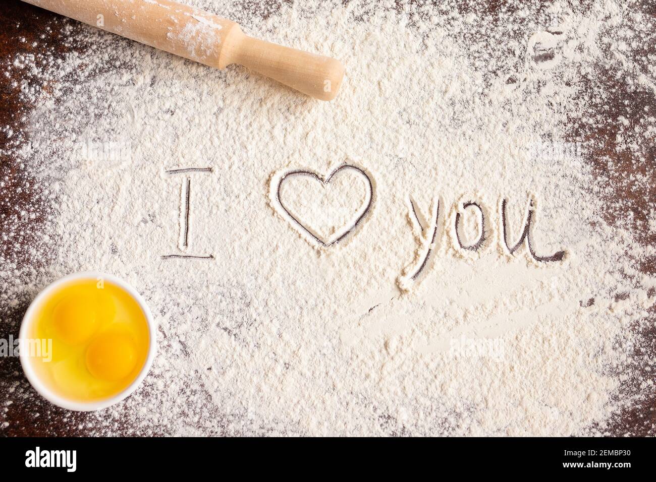 The inscription I love you on sprinkled flour, rolling pin and eggs. Baking recipes. Valentine's day concept. Declaration of love . High quality photo Stock Photo