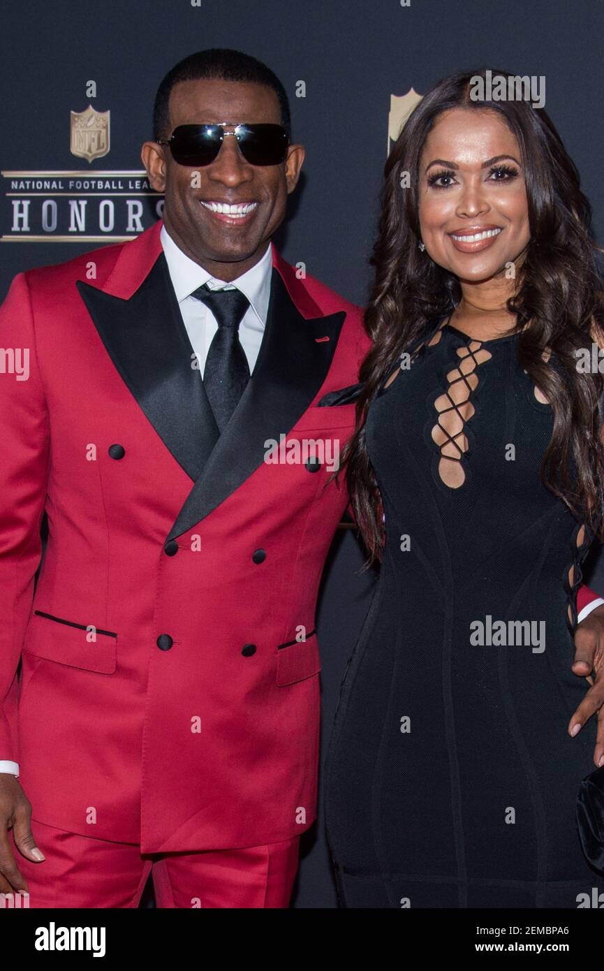 Deion Sanders and Tracey Edmonds walking the red carpet at the NFL
