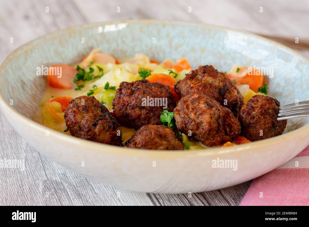 Köttbullar swedish meatballs with carrots and cabbage vegetables served on a plate Stock Photo