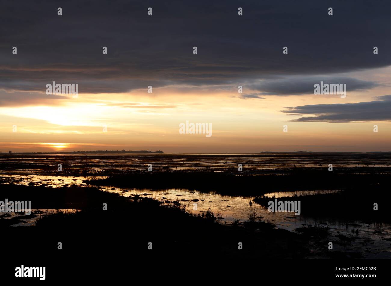 View across Holy Island Sands to Holy Island at sunrise, Northumberland, England, UK Stock Photo