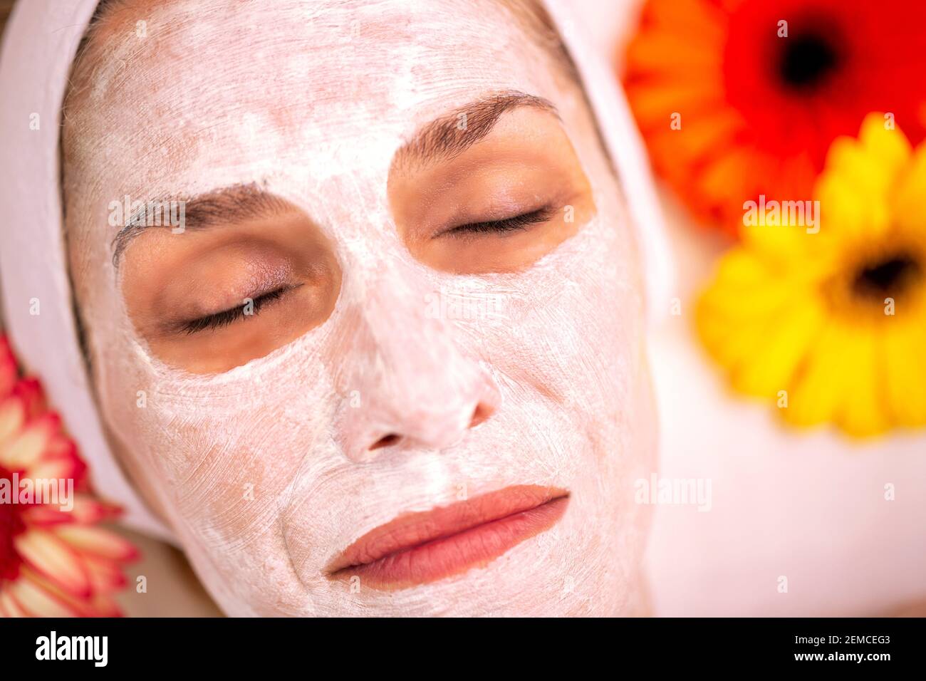Close up of a woman wearing a cosmetic face mask to draw out the