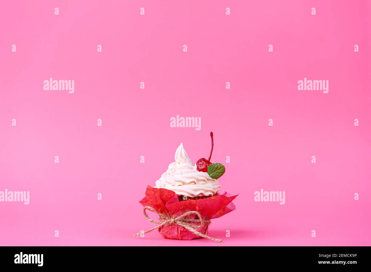 muffin with cream on a pink background. Stock Photo