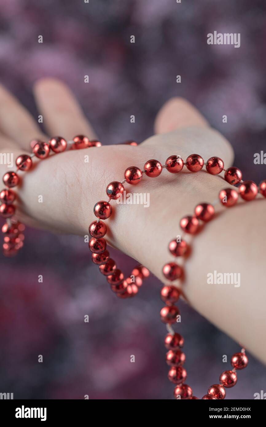 Red candy pearl necklace in the hand Stock Photo