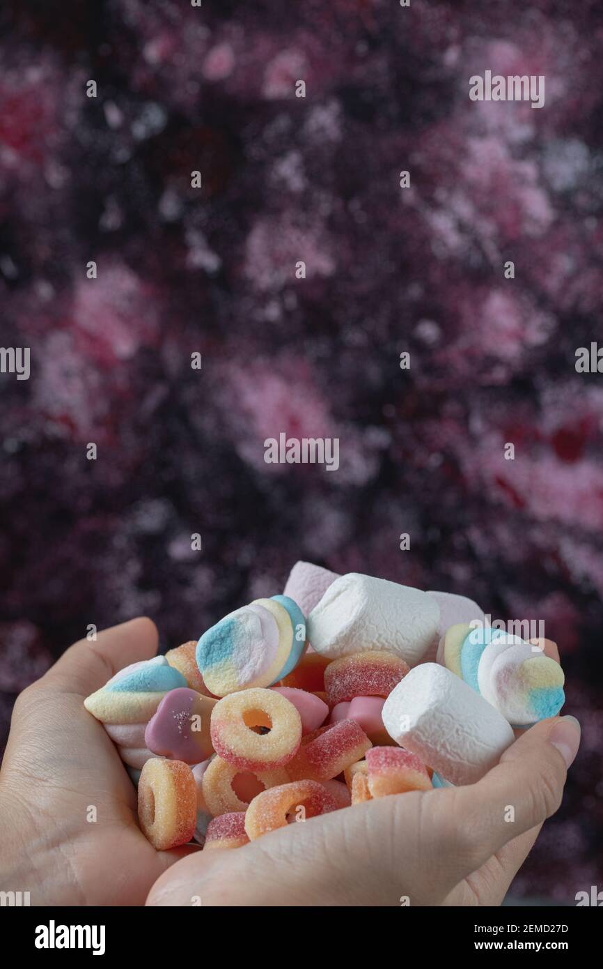 Holding marshmallow and jelly beans mix in the hand Stock Photo Alamy