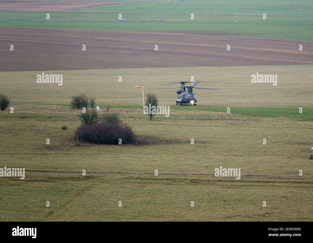RAF Boeing CH-47 HC6A Chinook helicopter flying very low for landing on a military exercise Stock Photo