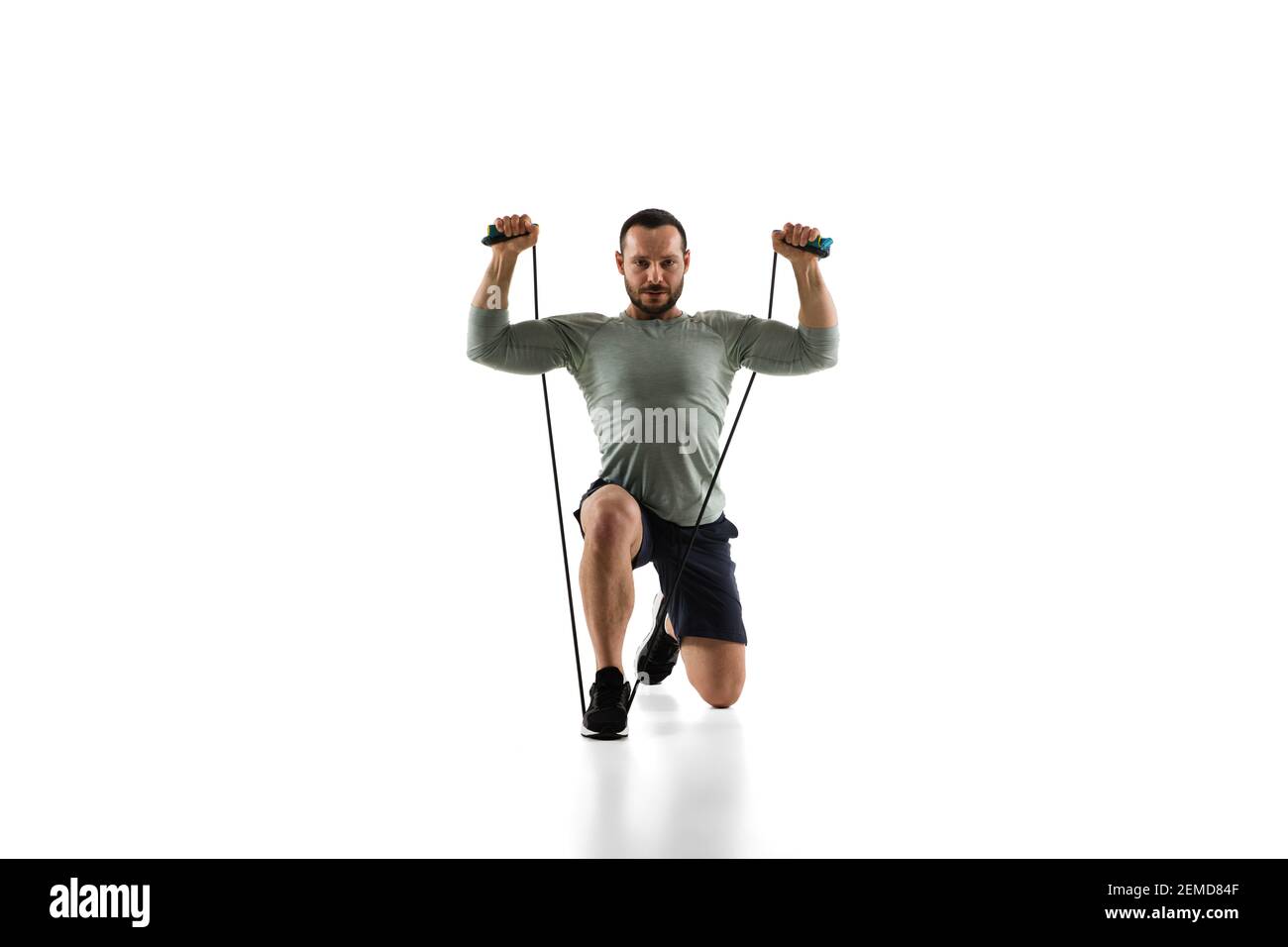 Jumping-rope. Young caucasian male model in action, motion on white ...