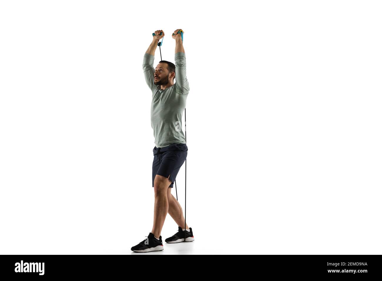 Man Using Jump Rope Model Jumping-rope. Young caucasian male model in action, motion on white ...