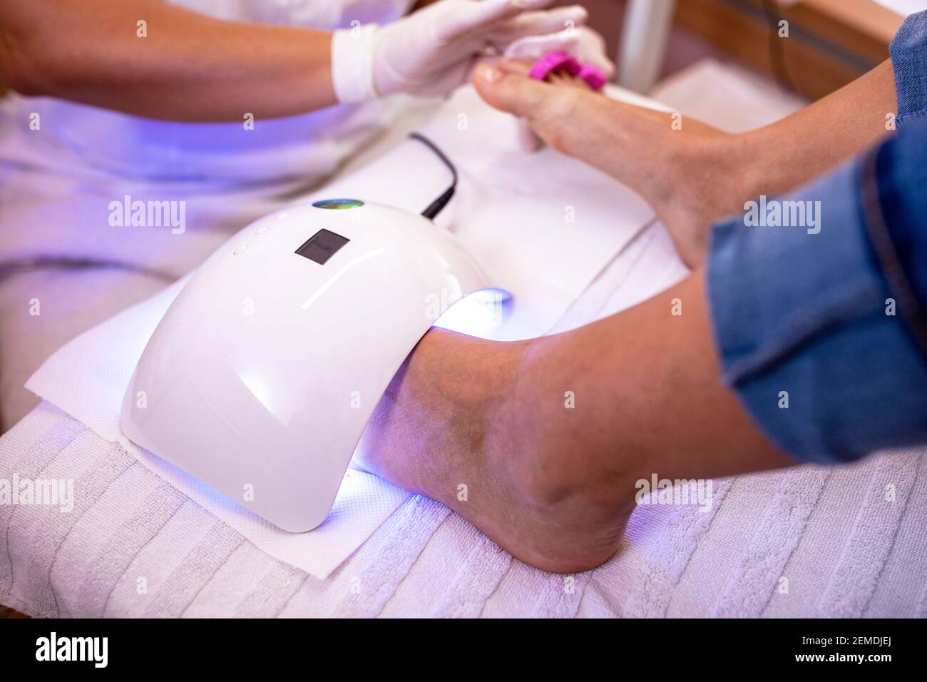 Pedicure concept with uv toenail drying, uv light nail polish drying on