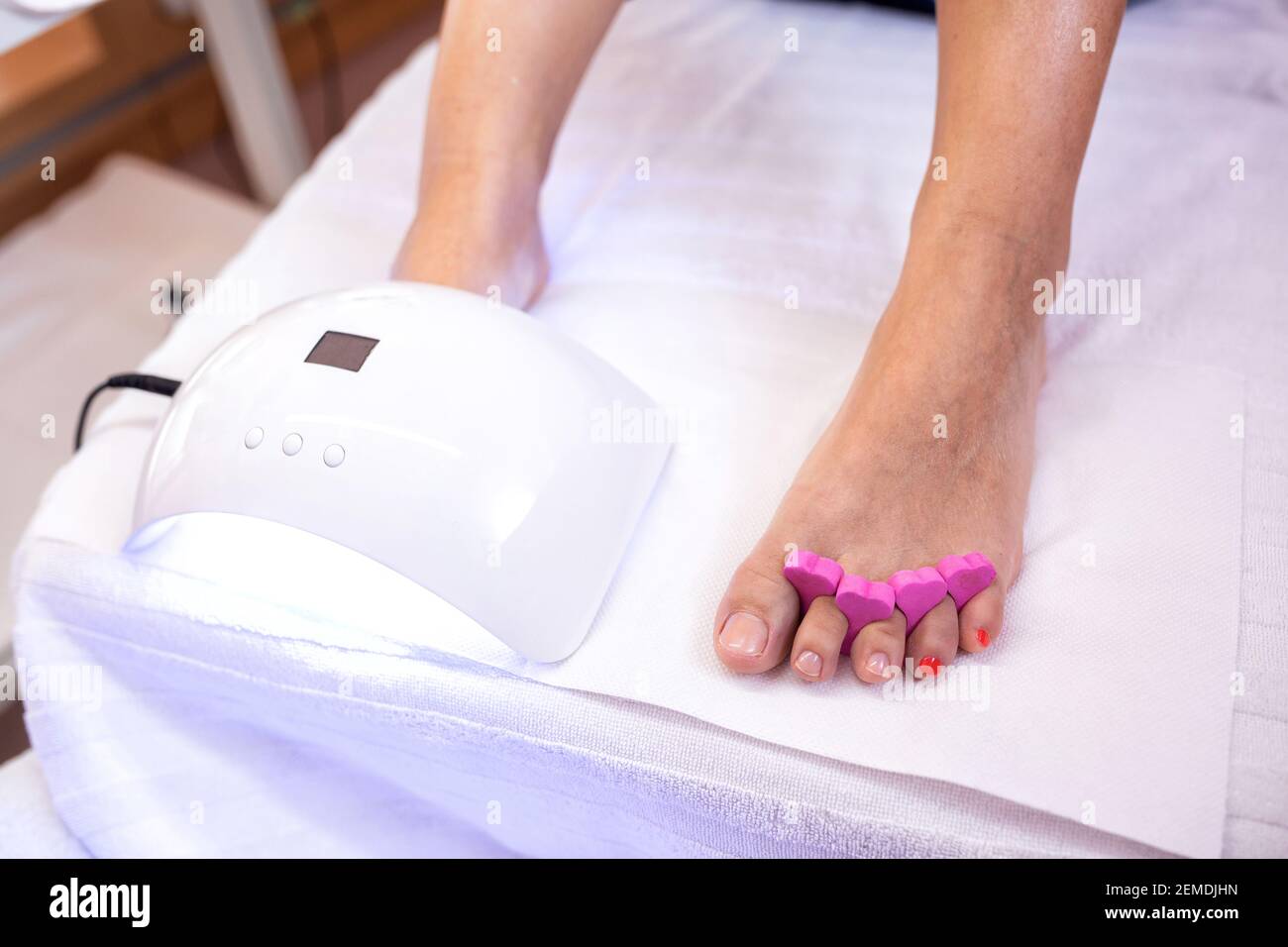 Pedicure concept with uv toenail drying, uv light nail polish drying on