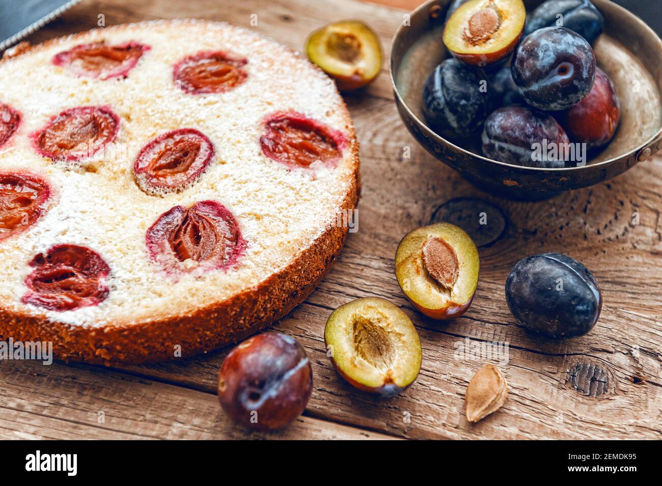 Pie with plum. In rustic style on a wooden surface Stock Photo