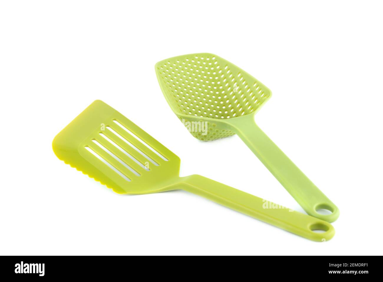 Green plastic kitchen utensils isolated on white background. Stock Photo