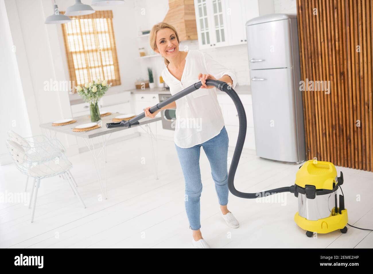 Blonde woman in cleaning vacuum hi-res stock photography and images - Alamy