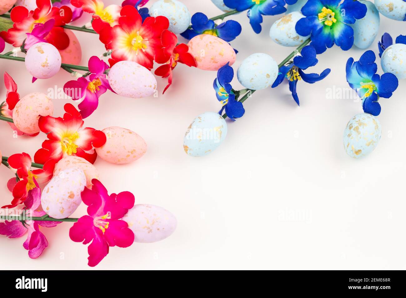 Easter colorful eggs and flowers on white background Stock Photo - Alamy