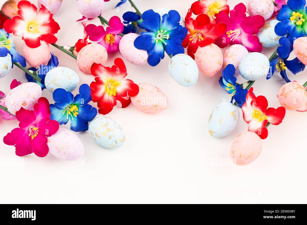 Easter colorful eggs and flowers on white background Stock Photo - Alamy