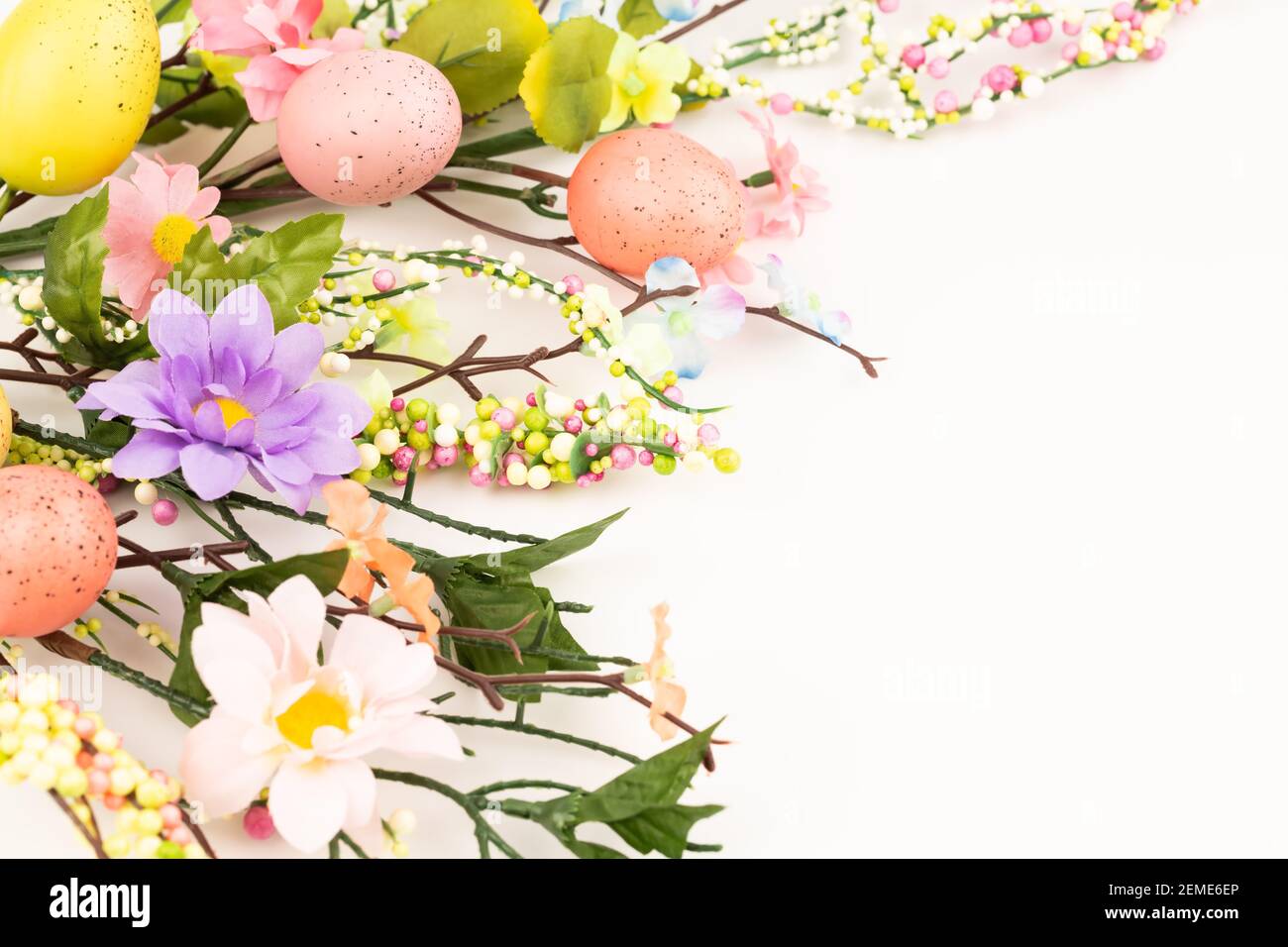 Easter colorful eggs and flowers on white background Stock Photo - Alamy