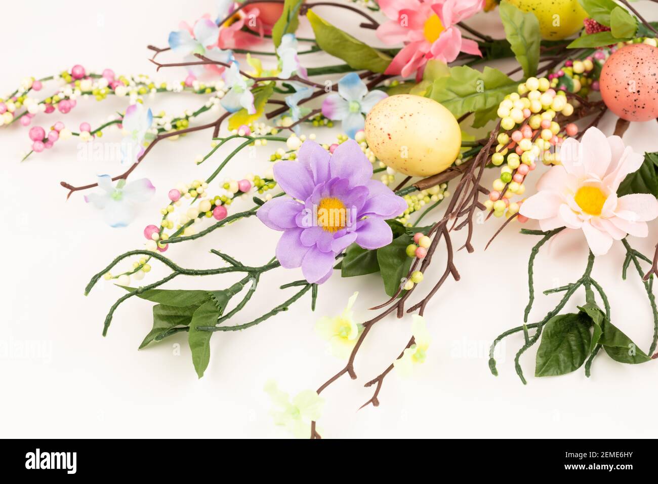 Easter colorful eggs and flowers on white background Stock Photo - Alamy