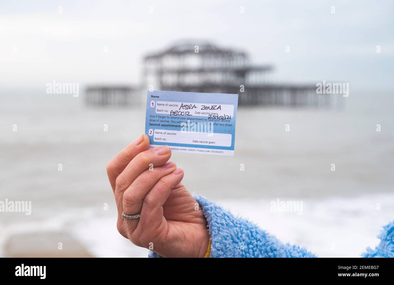 Brighton UK 25th February 2021 - Jennie Dack is happy after receiving her NHS COVID-19 coronavirus Astra Zeneca vaccination in Brighton this morning : Credit Simon Dack / Alamy Live News Stock Photo