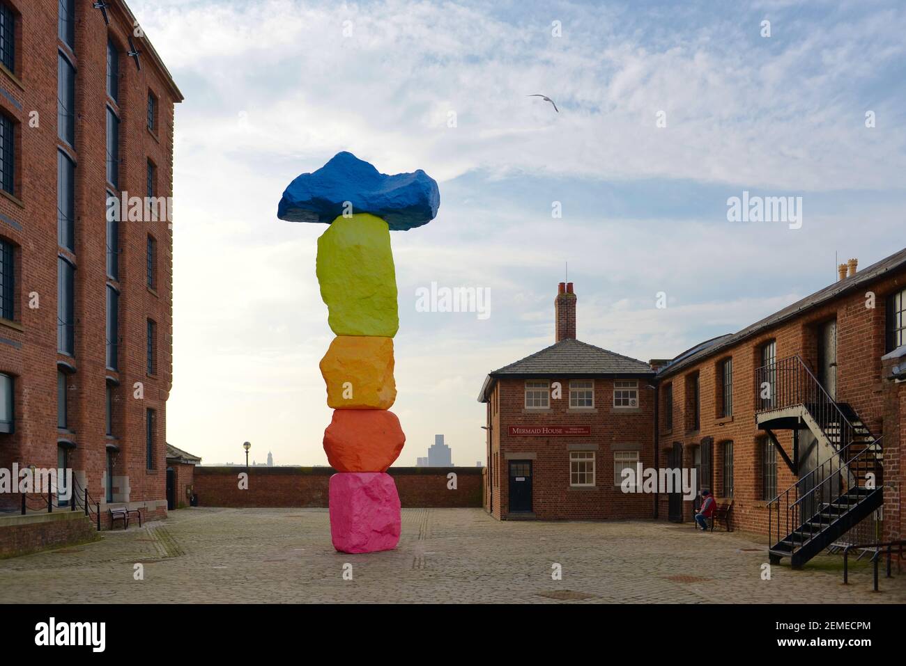 Liverpool, United Kingdom, 2nd February, 2020: Vibrant colors of the liverpool mountain sculpture by Ugo Rondinone against blue sky outside Tate. Stock Photo