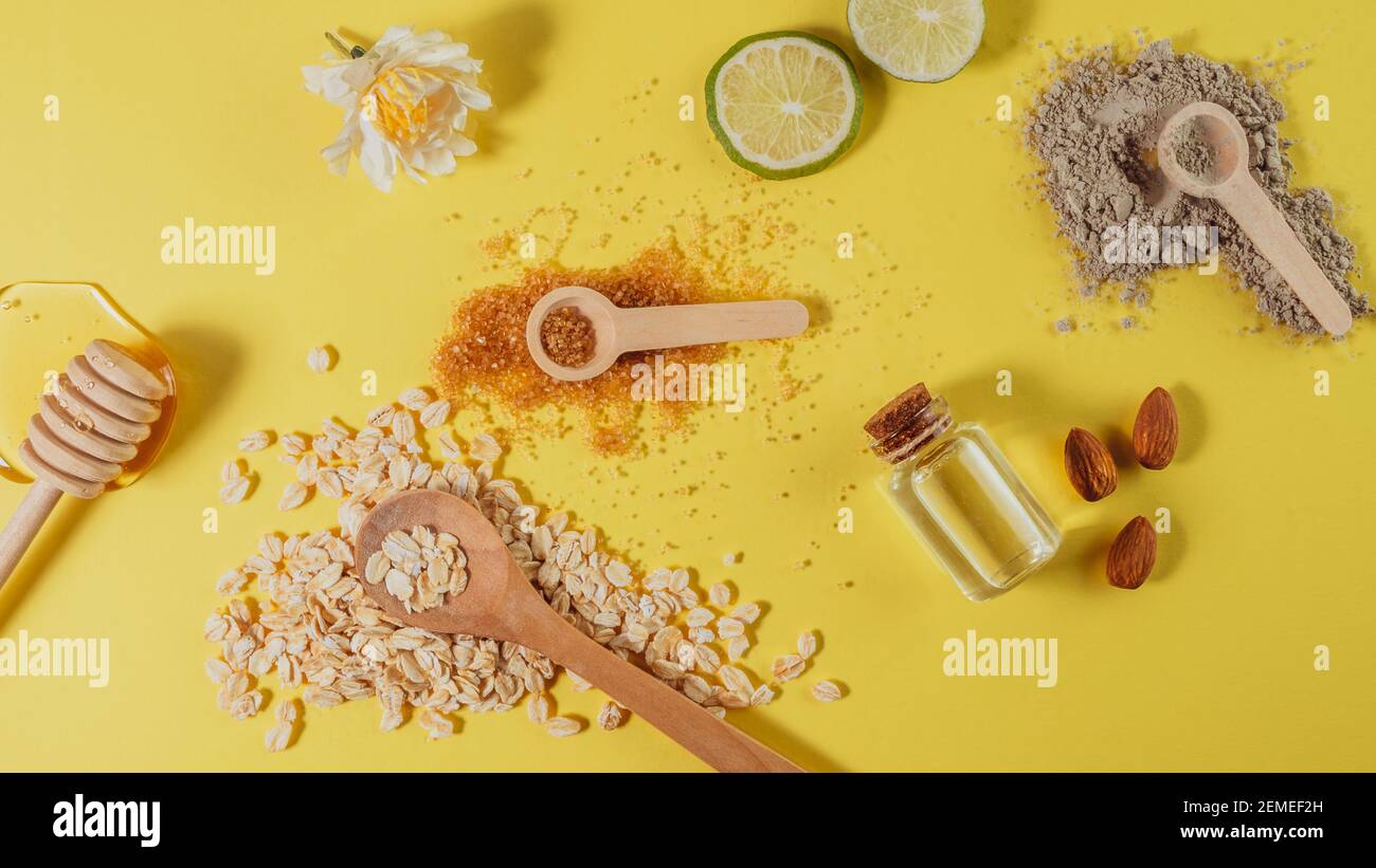 natural skin care products: honey, clay powder, brown sugar, almond oil, oats. Colorful background of natural cosmetics. natural ingredients for body Stock Photo