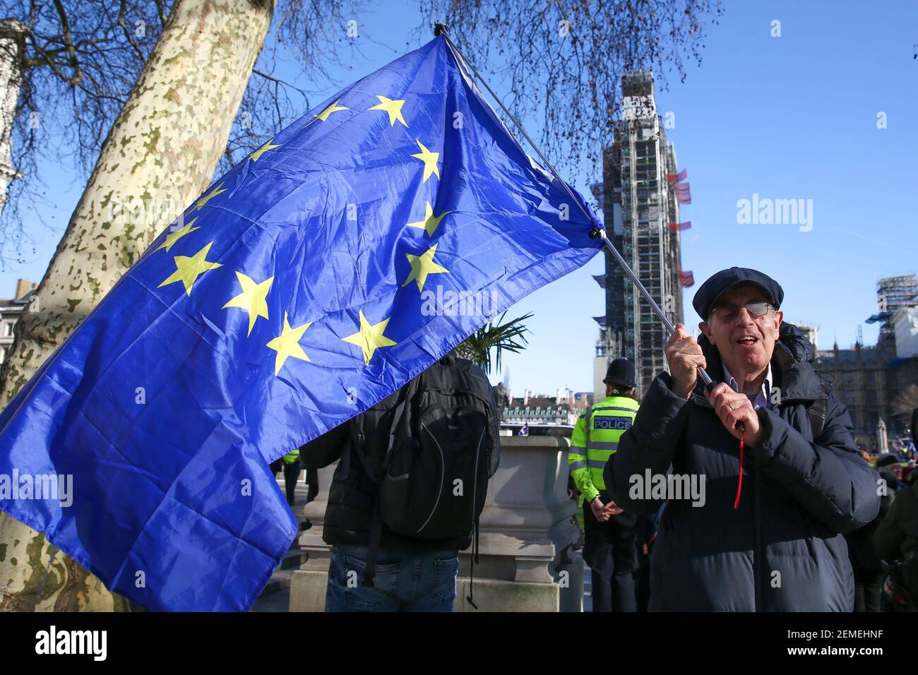 An anti-Brexit demonstrator is seen waving an European flag outside the  Houses of Parliament. MPs are set to debate and vote on the next steps in  the Brexit process later today as