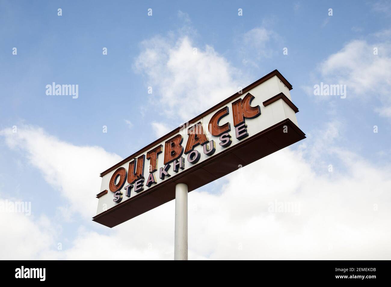 A logo sign outside of a Outback Steakhouse restaurant location in ...