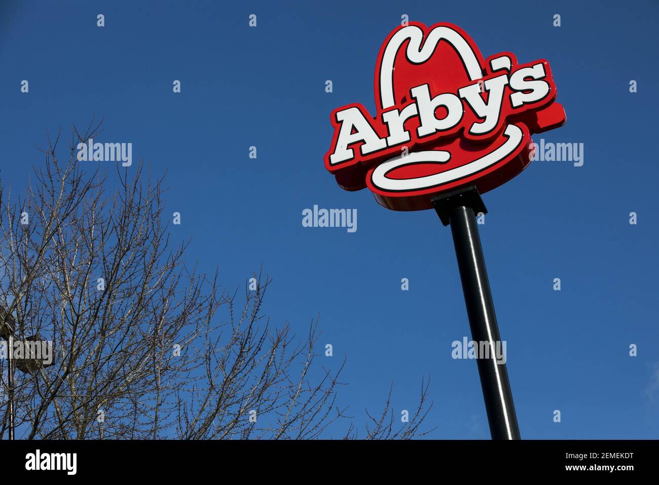 A logo sign outside of a Arby's restaurant location in Martinsburg, West Virginia on February 13