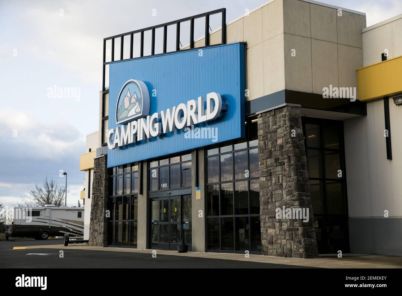 A logo sign outside of a Camping World retail store location in