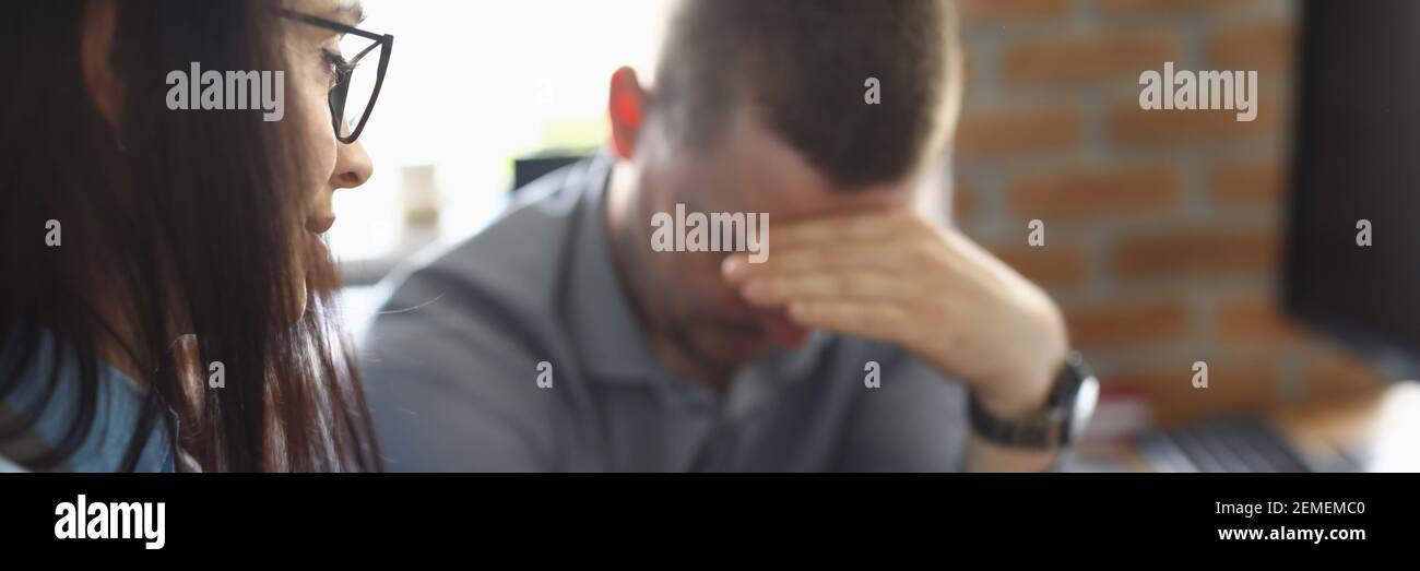 Man regret that he make mistake and sit sad with his head down. Stock Photo