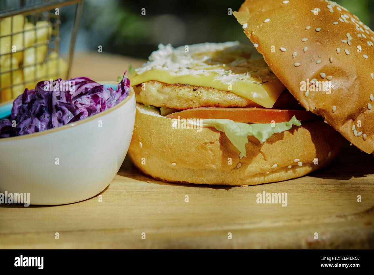 Delicious burger with french fries and sauce on wooden table Stock Photo