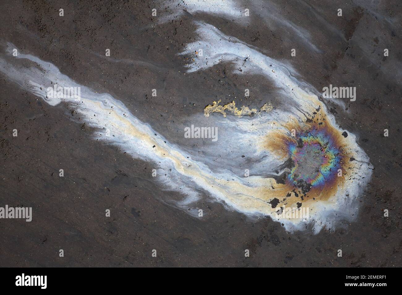 Oil spill on polluted concrete after petroleum leaking; color photo