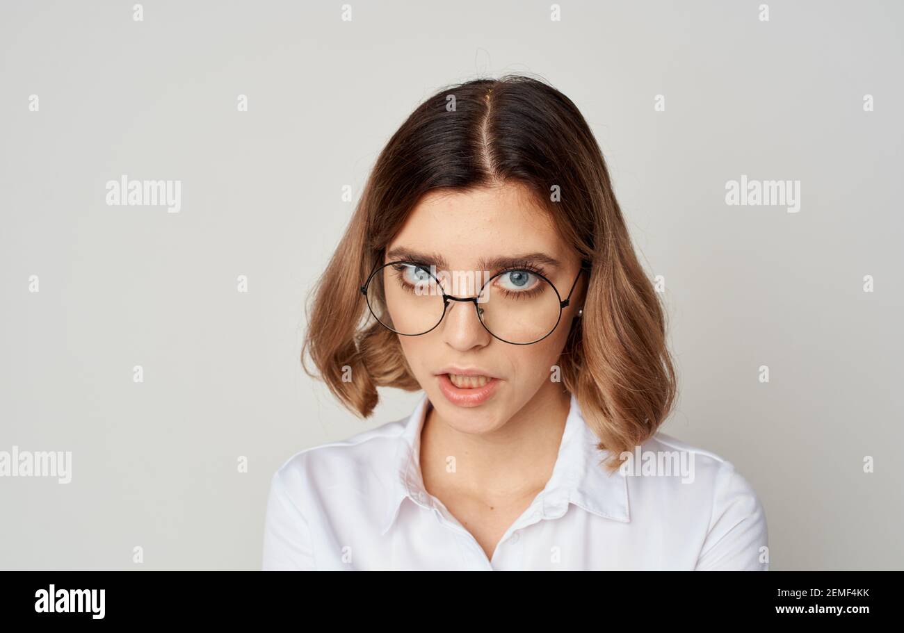 Beautiful woman wearing glasses short hair white shirt and beige background  Stock Photo - Alamy