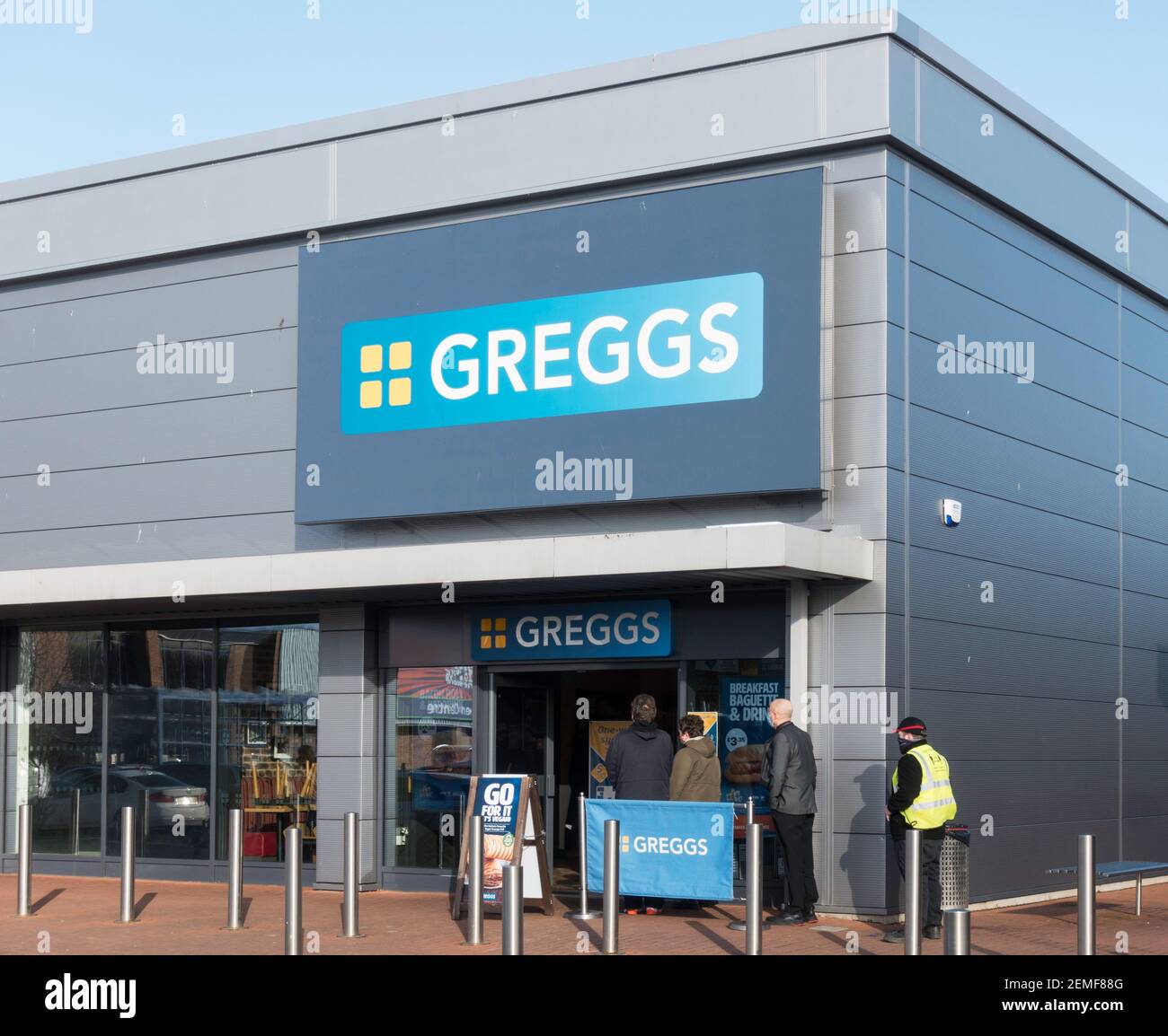 People wearing facemasks queuing to enter Greggs shop in Washington, north east England, UK Stock Photo