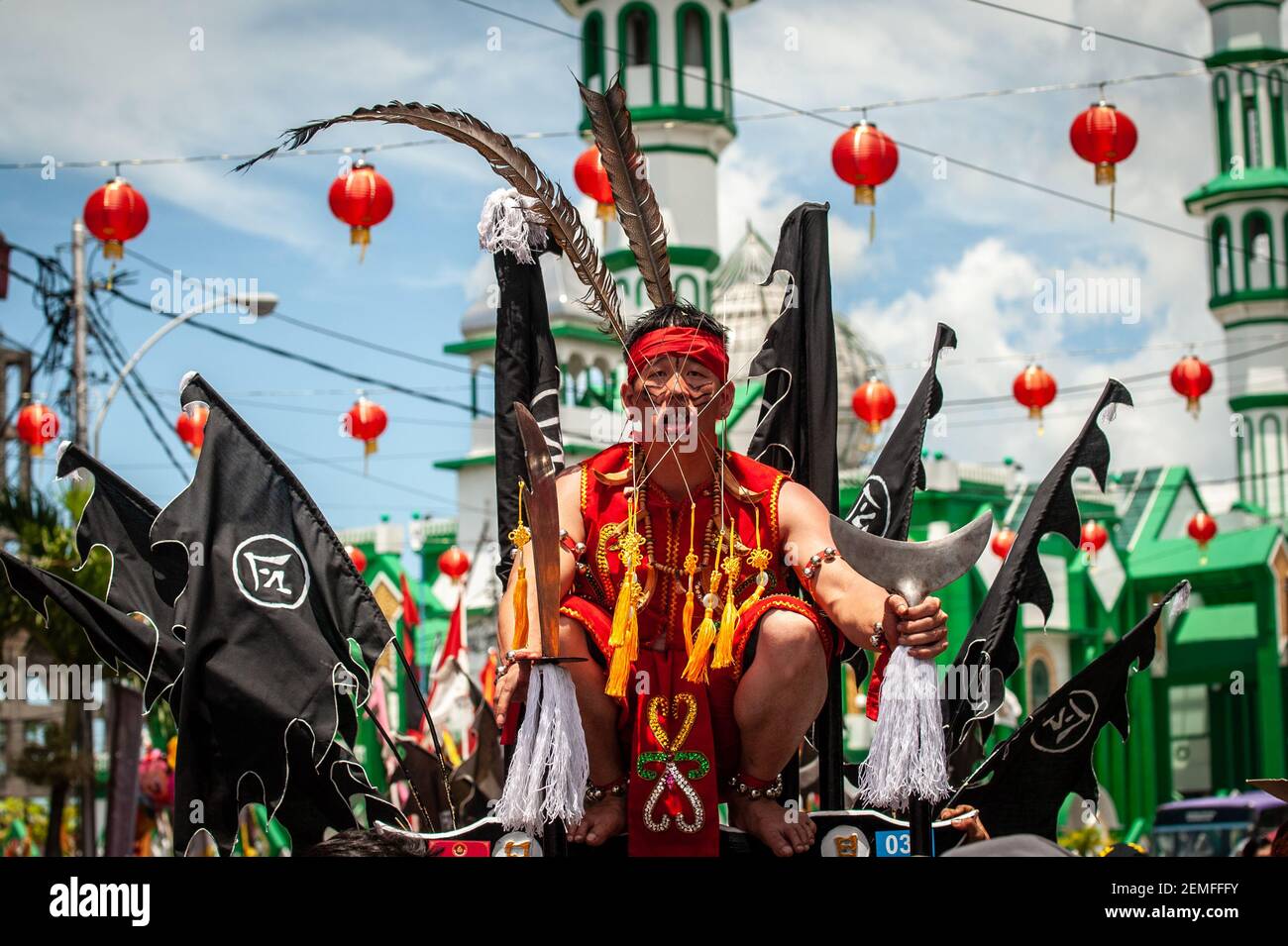A Tatung seen piercing a metal through his cheeks during the Cap Go Meh