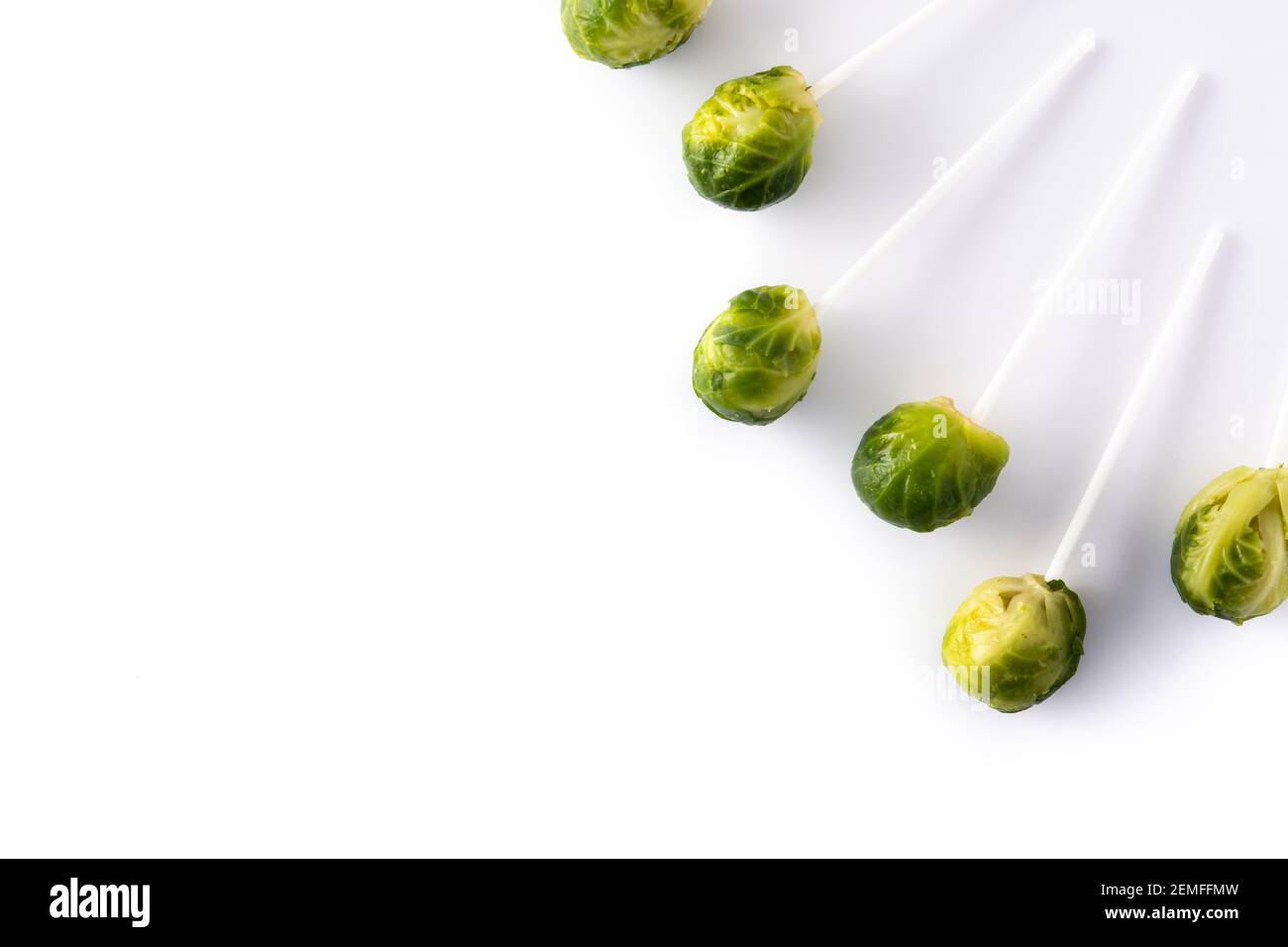 Set of brussel sprouts with lollipop sticks on white background Stock