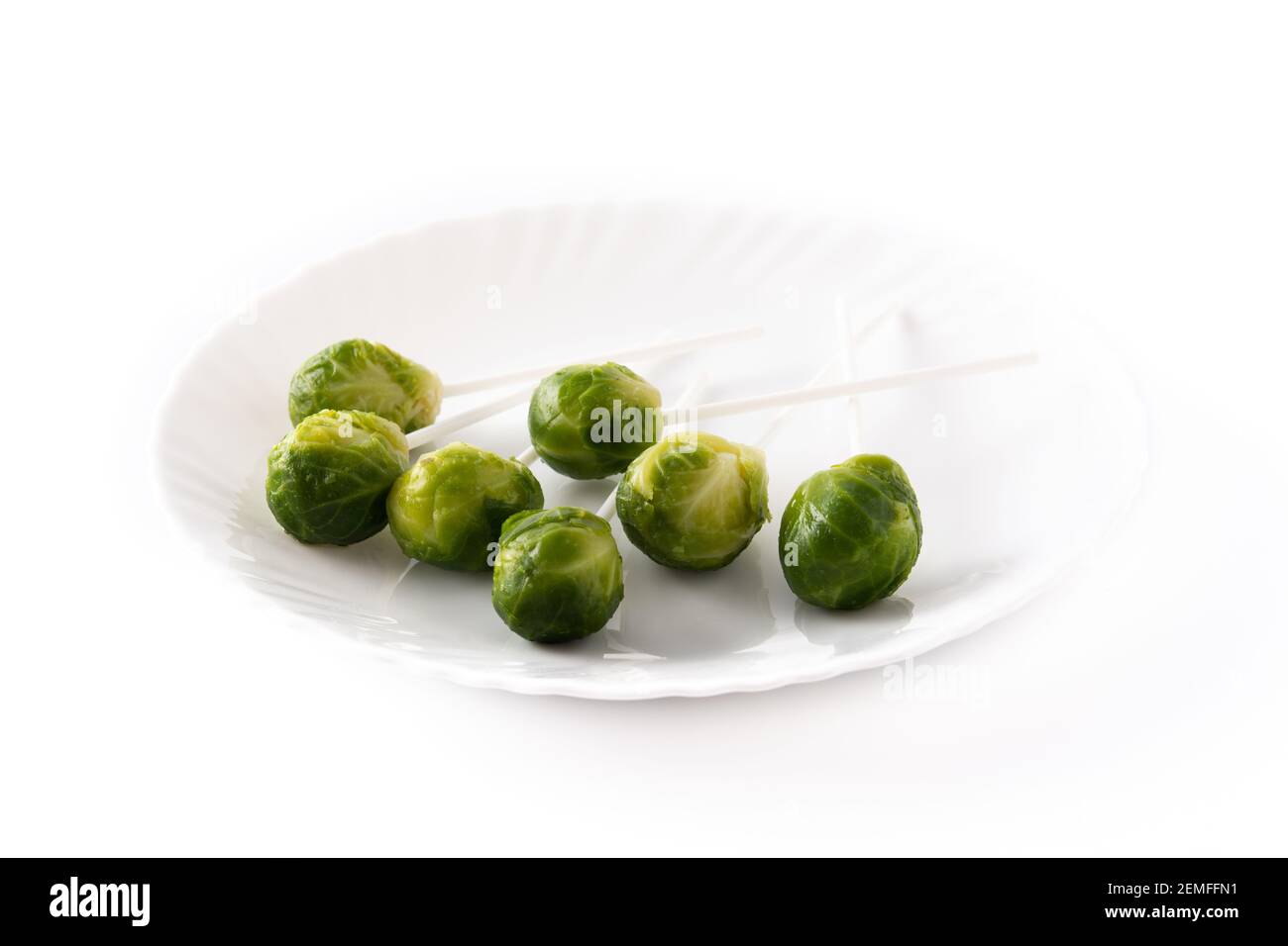 Set of brussel sprouts with lollipop sticks on white background Stock