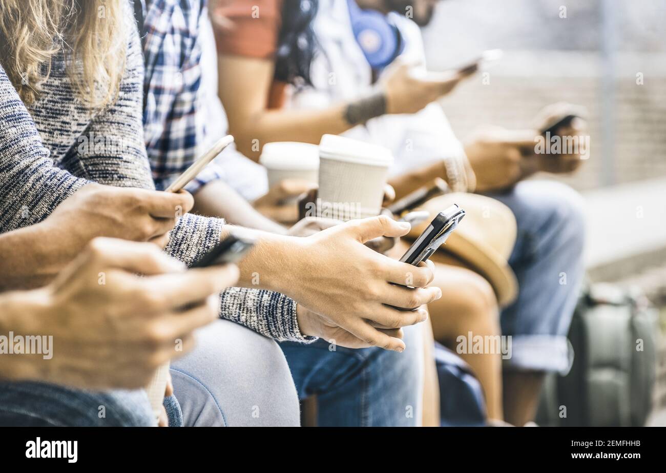 Multicultural friends group using smartphone with coffee at university college break - People hands addicted by mobile smart phone Stock Photo