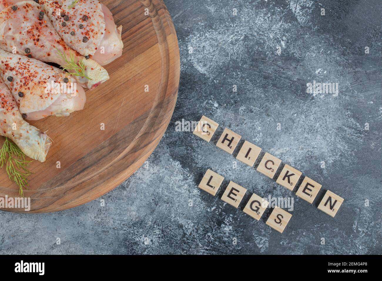 Fresh raw chicken legs with Cube letters Stock Photo - Alamy