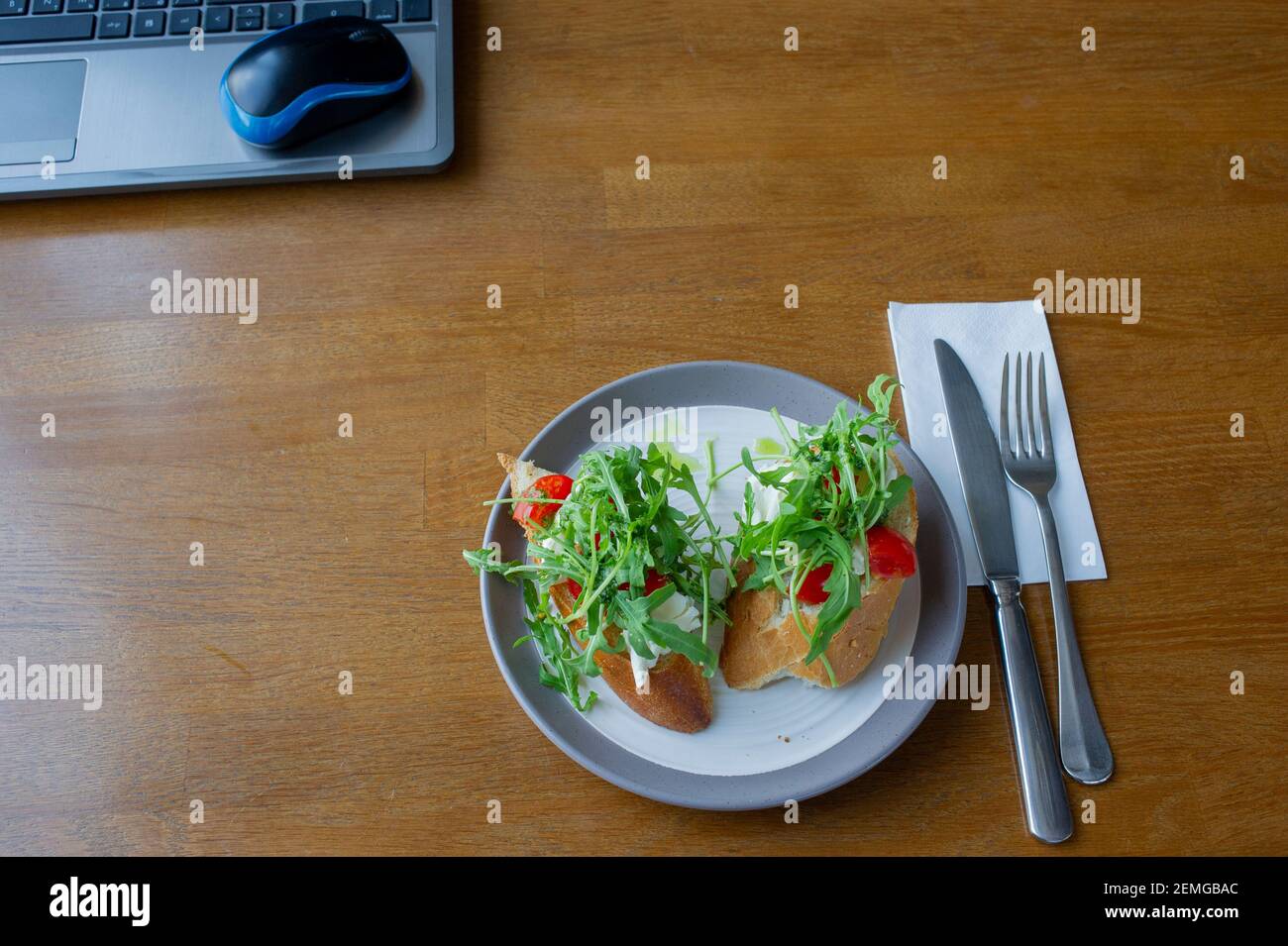 Healthy sandwich on office table. Laptop on the table and a sandwich ...