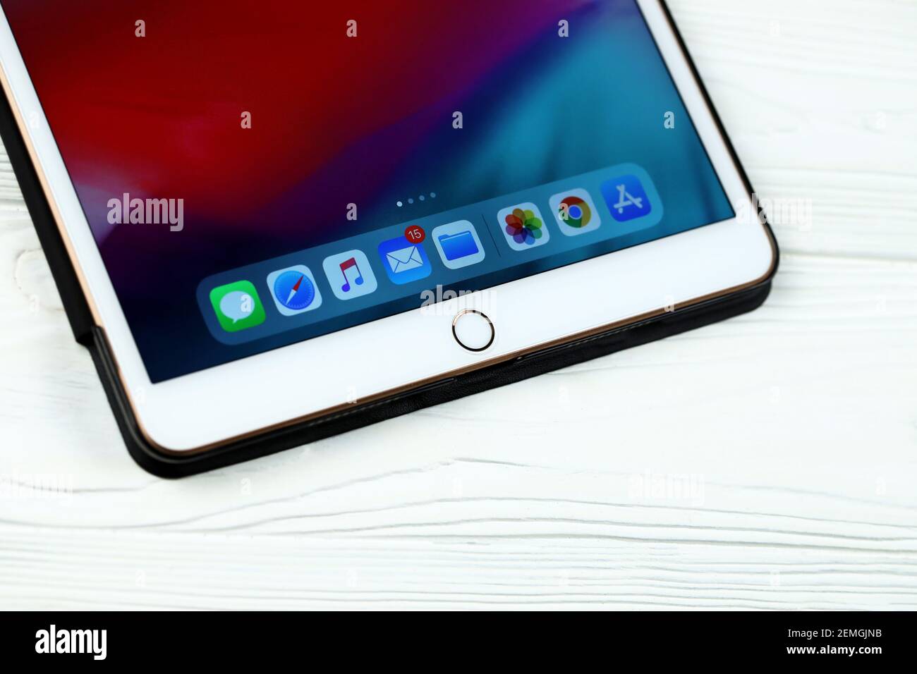 KHARKOV, UKRAINE - FEBRUARY 14, 2021: iPad Air 2 with IOS icons on display lies on white wooden table Stock Photo