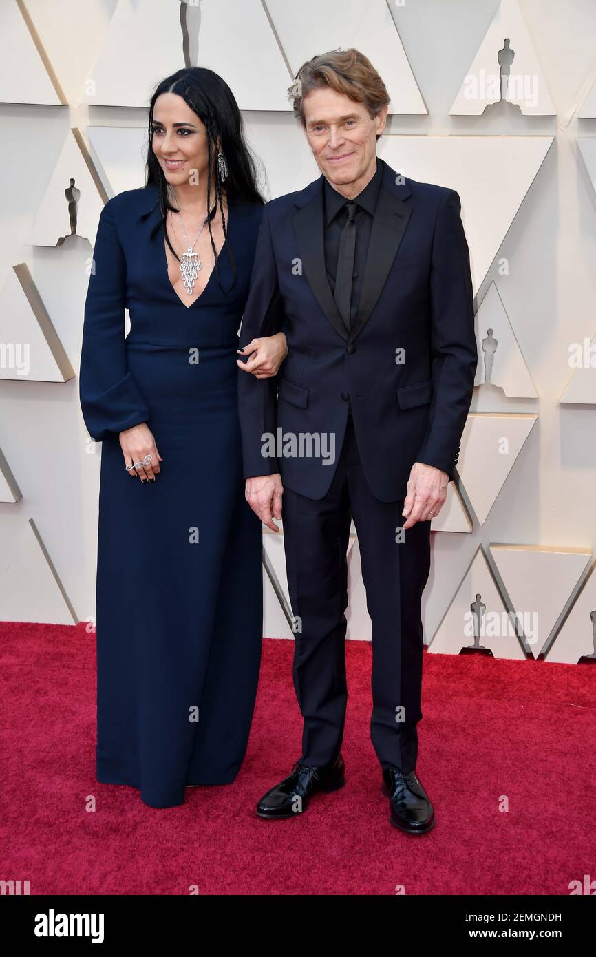 Willem Dafoe and Giada Colagrande walking on the red carpet at the 91st