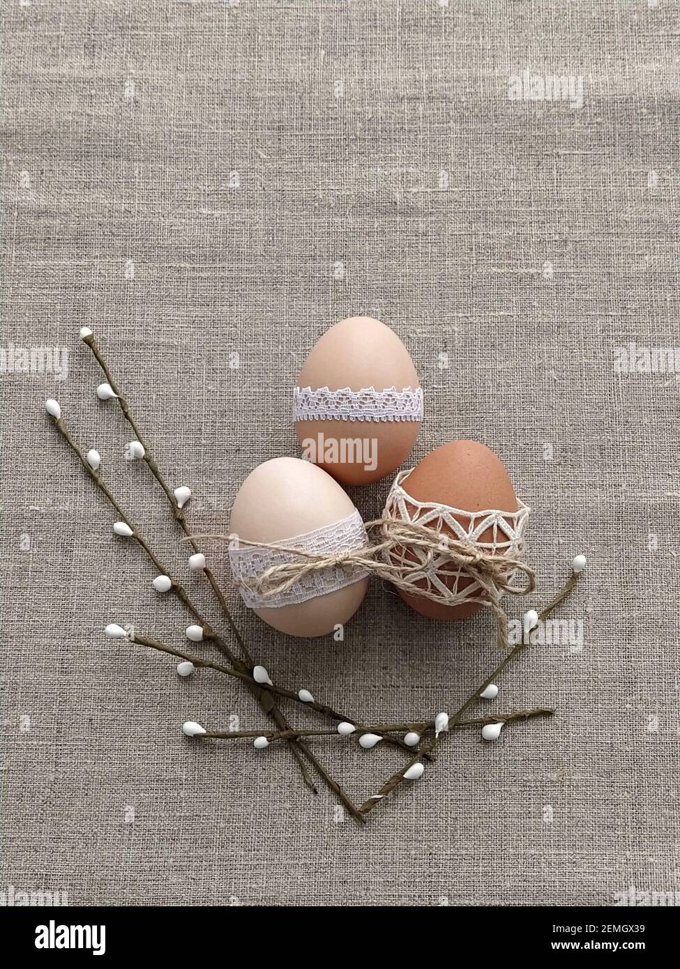 Easter composition decorated by lace Easter eggs on linen background Stock Photo