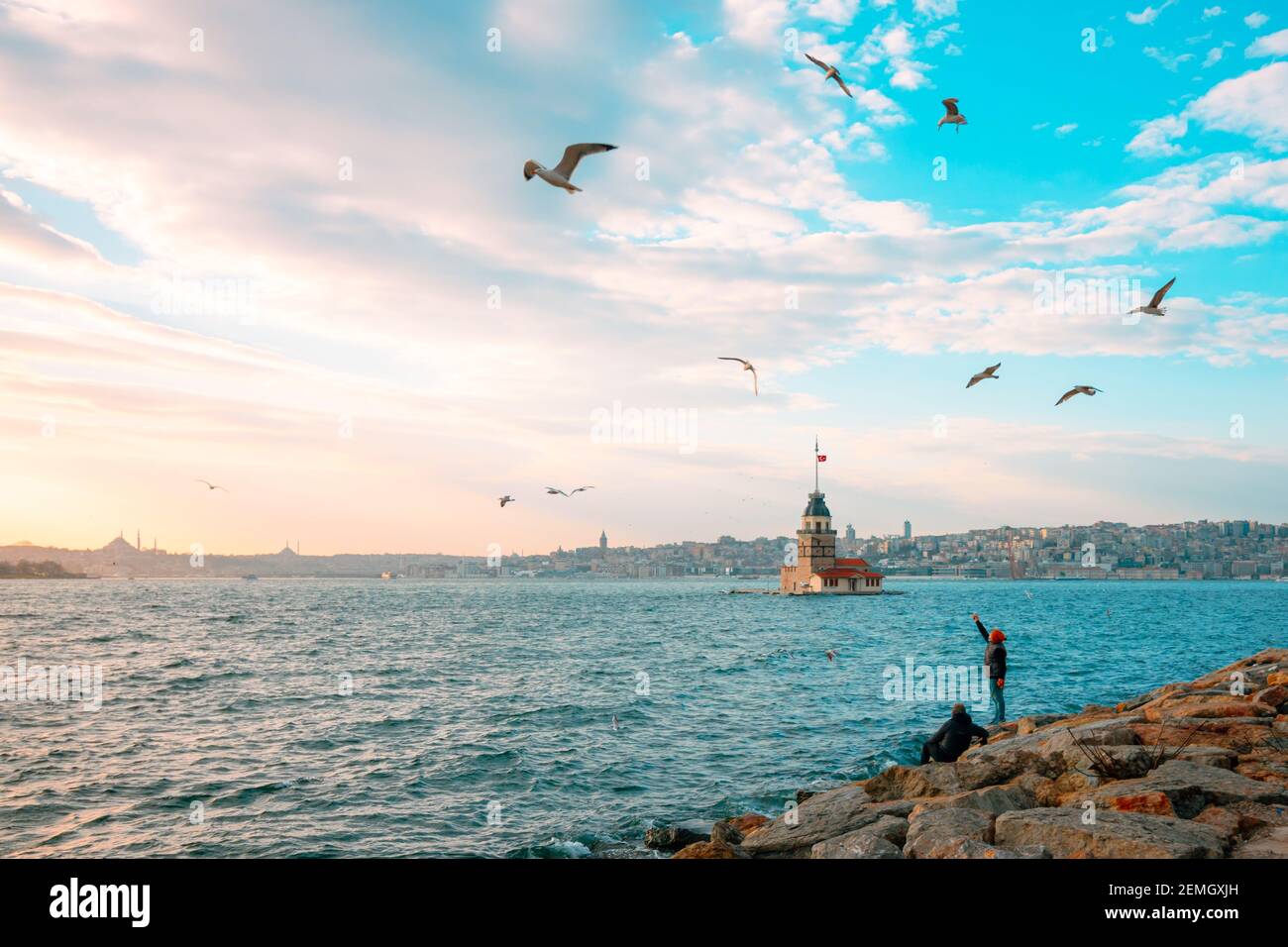 Maiden's Tower and Seagulls at sunset. Kiz Kulesi at sunset in Istanbul. Istanbul background photo. Travel to Istanbul. Sunset and cityscape of Istanb Stock Photo
