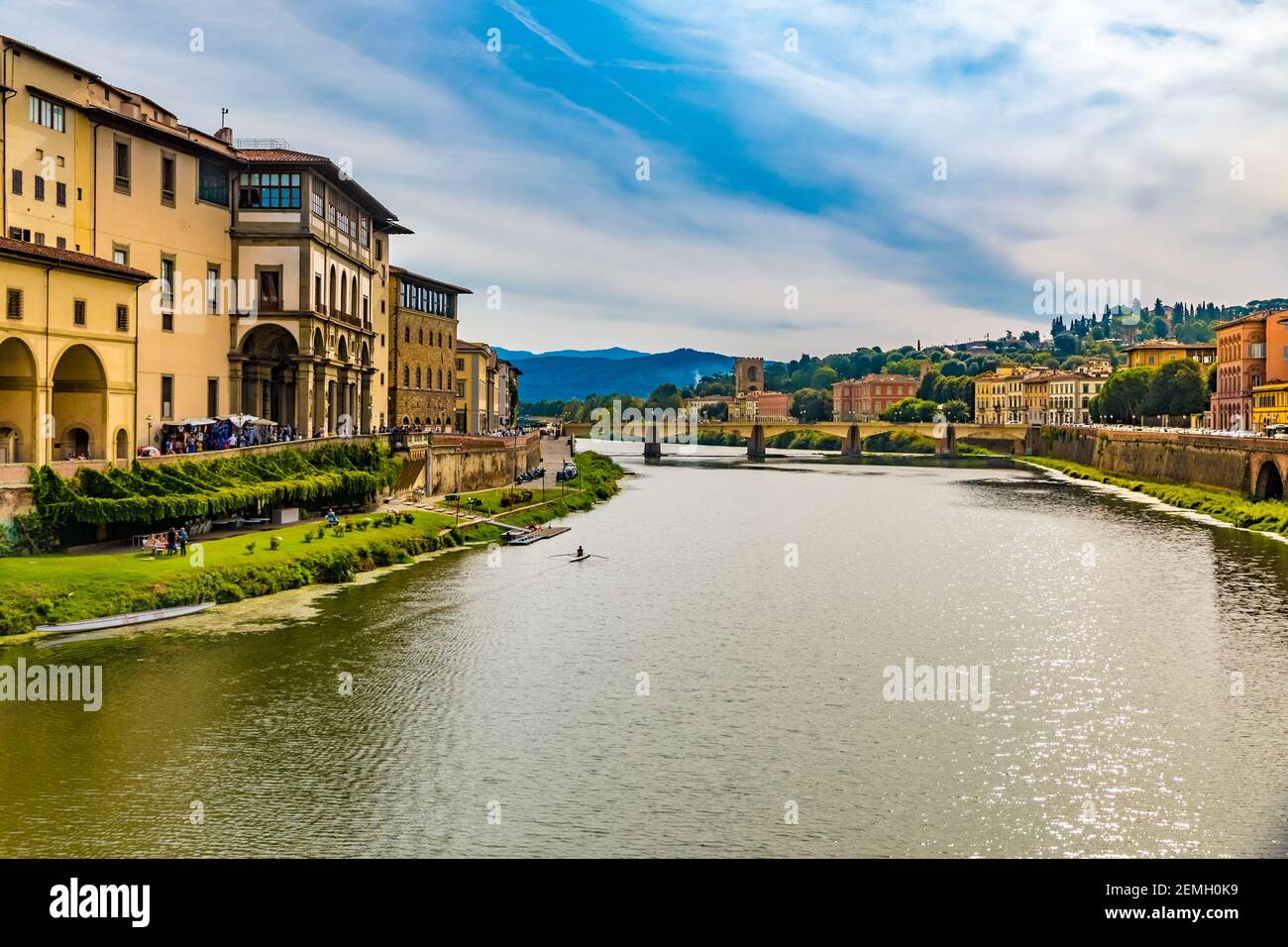 Beautiful panoramic landscape view of the Arno River with the famous bridge Ponte alle Grazie on a sunny day with a blue sky in Florence, Italy. A... Stock Photo